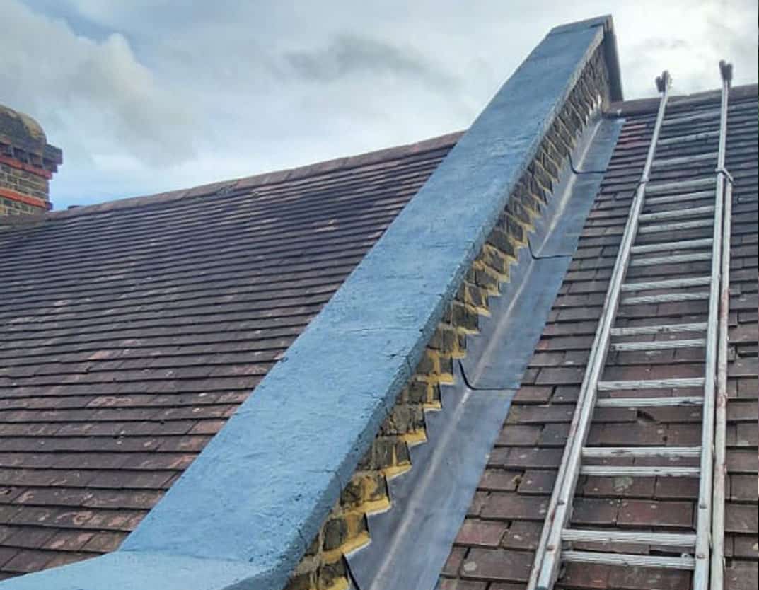 claygate roofing and guttering ladder on roof